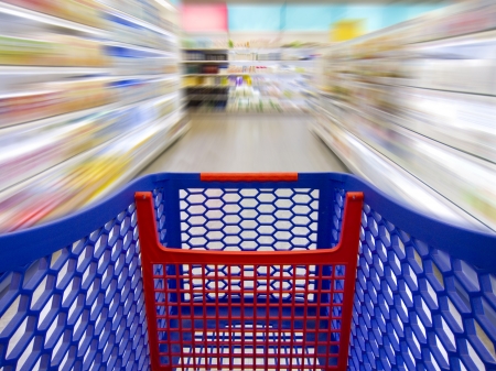 Trolley over a blurred background in a supermarket as a concept of fast shoppingの写真素材