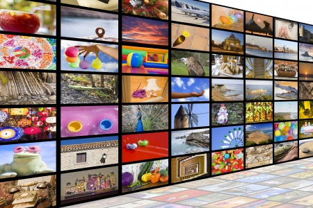 Big TV videowall with different channels in a white room with reflectionの写真素材