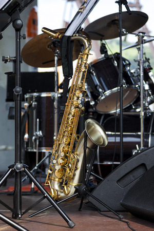 Saxophone resting among other instruments before a music concertの写真素材