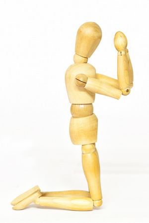 Conceptual representation of praying with wooden mannequinの写真素材