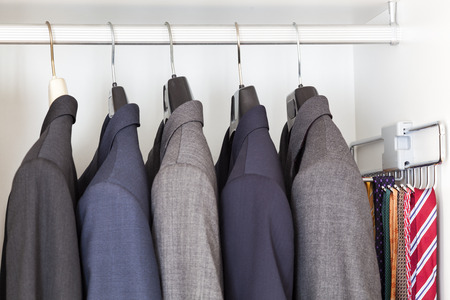 Man suits and ties inside a wardrobeの写真素材