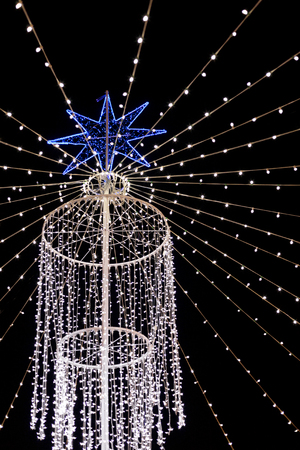Outdoor Christmas lighting with a blue starの写真素材