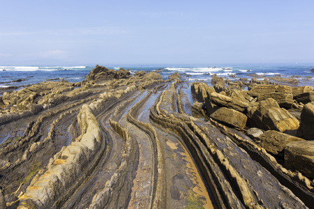 Curved flysch formation in the shorelineの写真素材