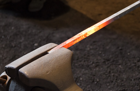 Red hot steel bar in a blacksmith's forgue