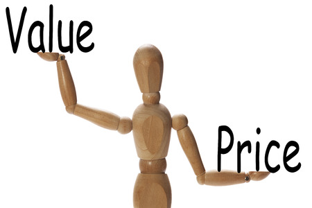 Mannequin measuring the importance of value versus price on the palms of the handsの写真素材