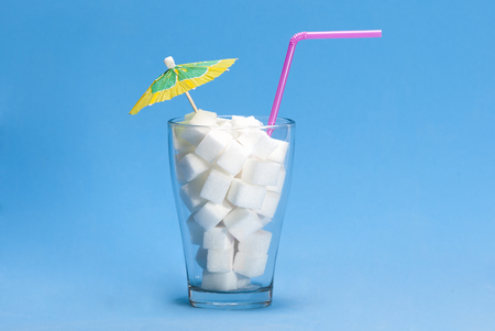 Glass with sugar cubes as a concept of drink with too much sugarの写真素材