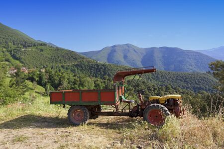 Old two wheeled tractor in the mountains close to a small villageの写真素材