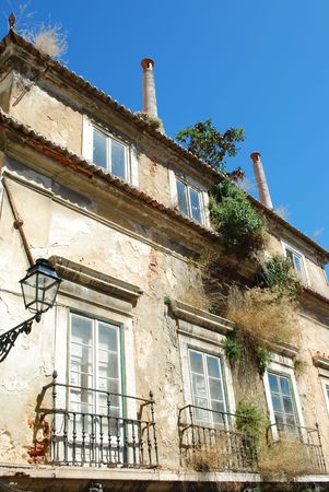 rusty building facade with antique lamp on the wallの写真素材
