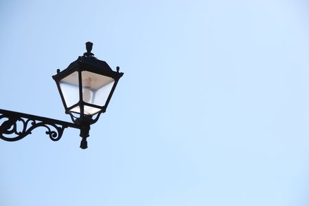 old vintage lantern against blue sky backgroundの写真素材
