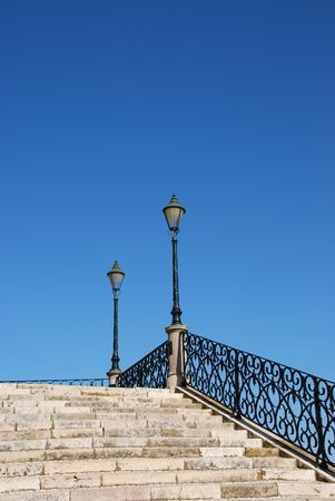 beautiful close up of a typical stairway made of calcada pavement with a gorgeous retro lamp postの写真素材