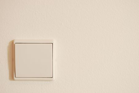 white light switch against white wall (plenty copy-space)の写真素材