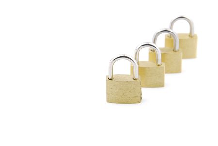 golden closed padlocks isolated on white background (focus on the first)の写真素材
