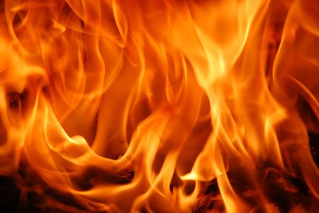 beautiful flames burning on a cozy fireplaceの写真素材