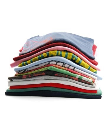 pile of colorful t-shirts isolated on white backgroundの写真素材