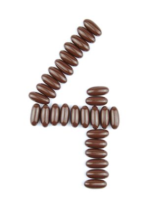 number 4 with chocolate candies (isolated on white background)の写真素材