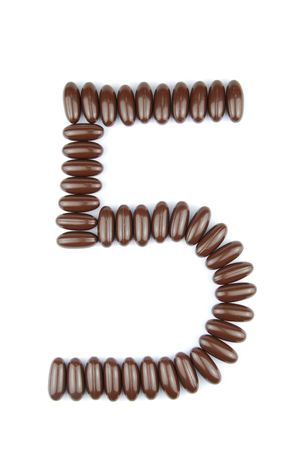 number 5 with chocolate candies (isolated on white background)の写真素材