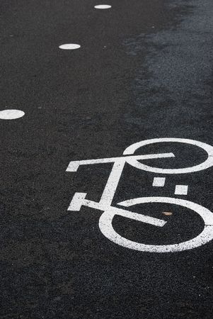 white bicycle road sign painted on the asphalt road (bicycle lane)の写真素材