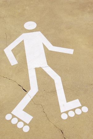 white rollerblading sign on a urban park (yellow cement surface)の写真素材
