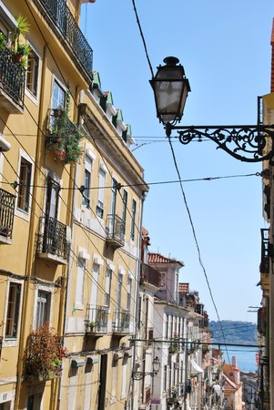 beautiful and traditional view of antique building and lamp in Lisbon, Portugal (river tagus background)の写真素材