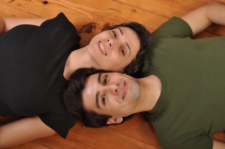 lovely friendship between sister and brother lying and relaxing on the floorの写真素材