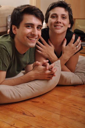lovely friendship between brother and sister lying and relaxing on the floorの写真素材
