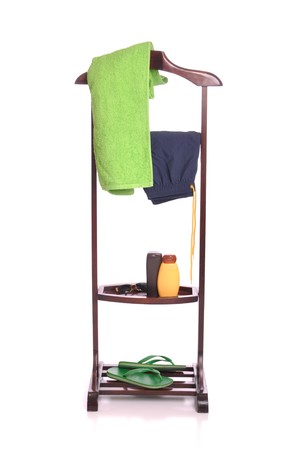 man beach clothing on a wooden hanger with  towel, swimsuit, sun lotion, sunglasses and flip-flops (isolated on white background)の写真素材