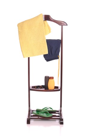 man beach clothing on a wooden hanger with  towel, swimsuit, sun lotion, sunglasses and flip-flops (isolated on white background)の写真素材