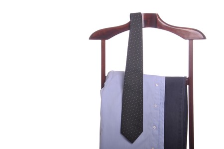business man clothing on a wooden hanger with shirt, tie and trousers (isolated on white background)の写真素材