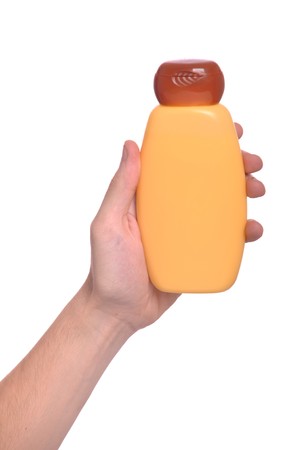 man hand holding sun lotion bottle (isolated on white background)の写真素材