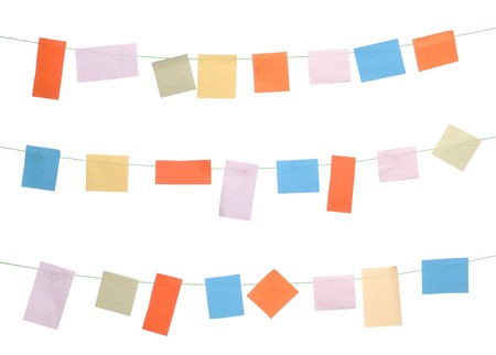 set of colored sticky notes hanging on wire (isolated on white background)の写真素材