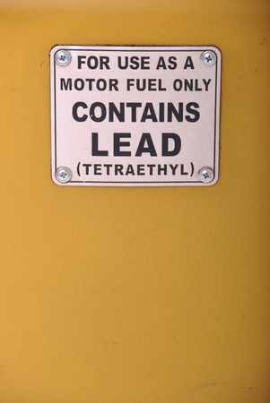 contains lead vintage sign on a yellow gas pump background