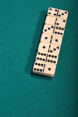 domino pieces on a green cloth backgroundの写真素材