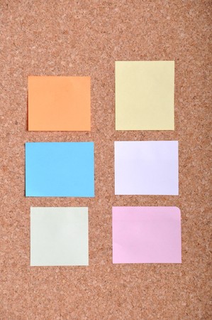 many colorful sticky notes on a bulletin boardの写真素材