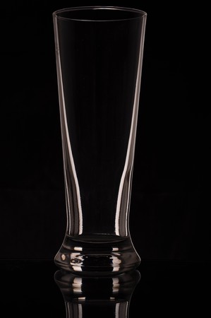 tall beer glass isolated on black backgroundの写真素材