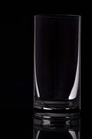 empty water glass isolated on a black backgroundの写真素材