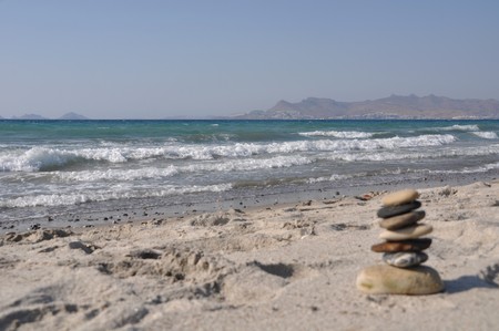 beautiful Kos beach with defocused pebble stack, Greece (Turkey on background)の写真素材