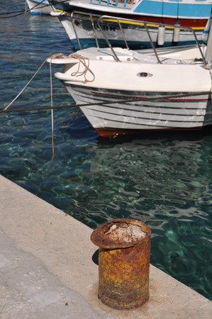 rusty metal mooring bollard at Pserimos docks, Greeceの写真素材
