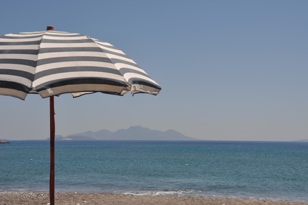 gorgeous beach scene with greek umbrella at Kefalos beach (Kos), Greeceの写真素材