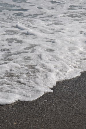 gorgeous beach sand and sea foam (copy-space available)の写真素材