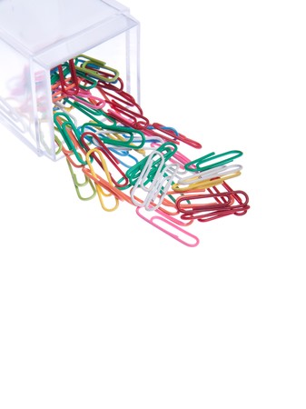 colored paper clips outside a plastic box isolated on white backgroundの写真素材