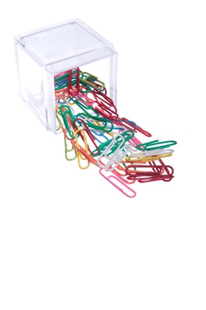 colored paper clips outside a plastic box isolated on white backgroundの写真素材