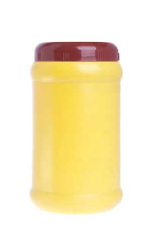 yellow chocolate powder plastic bottle brown cap isolated on white backgroundの写真素材