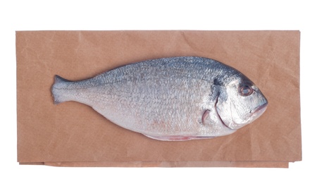 raw dorado fish on market paper bag (isolated on white background)の写真素材