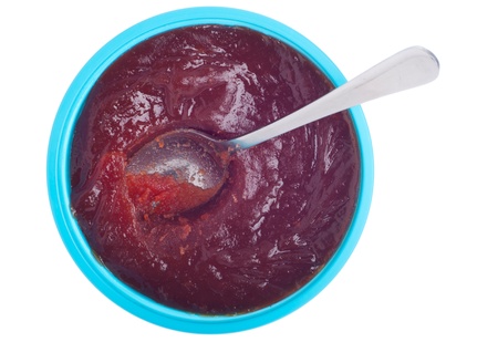 homemade marmalade bowl with spoon isolated on white backgroundの写真素材