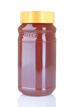 big jar of homemade honey isolated on white background の写真素材