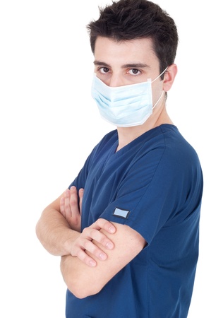 confident young male doctor wearing mask isolated on white background (folded arms)の写真素材