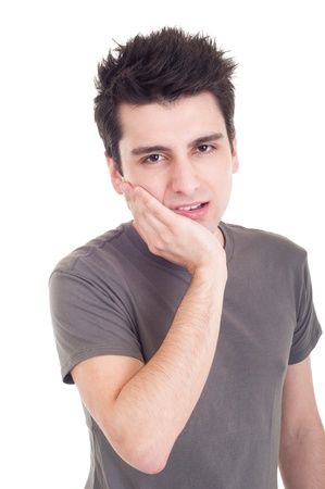 young casual man having a toothache isolated on white backgroundの写真素材