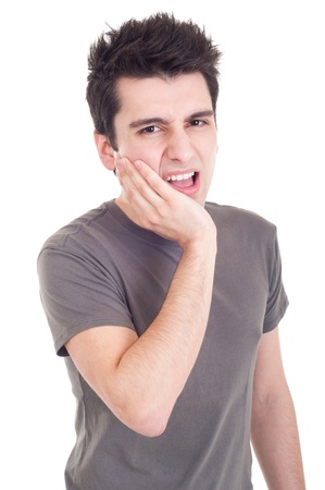 young casual man having a toothache isolated on white backgroundの写真素材