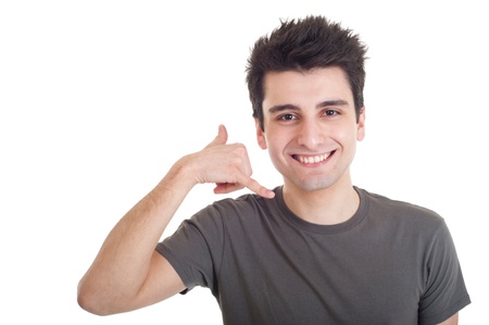 smiling casual man showing call me gesture isolated on white backgroundの写真素材