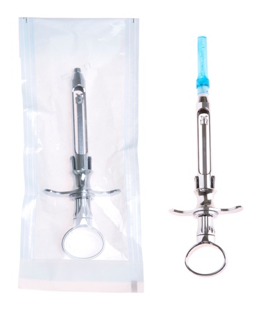 dental syringe in and out a sterilized pouch (isolated on white background)の写真素材